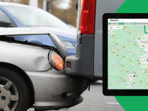 A silver car rear-ends a gray van on the road. A digital map interface is displayed on a nearby screen.