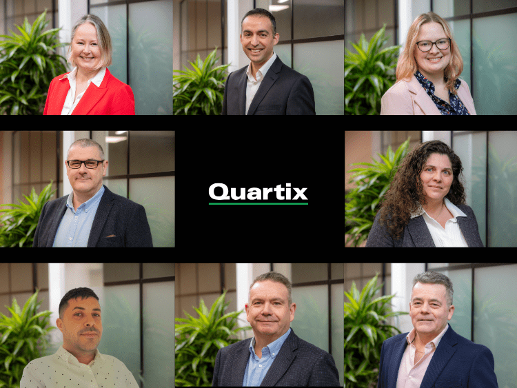 Eight people arranged around a central logo reading "Quartix," each standing in front of a blurred office background with plants visible.